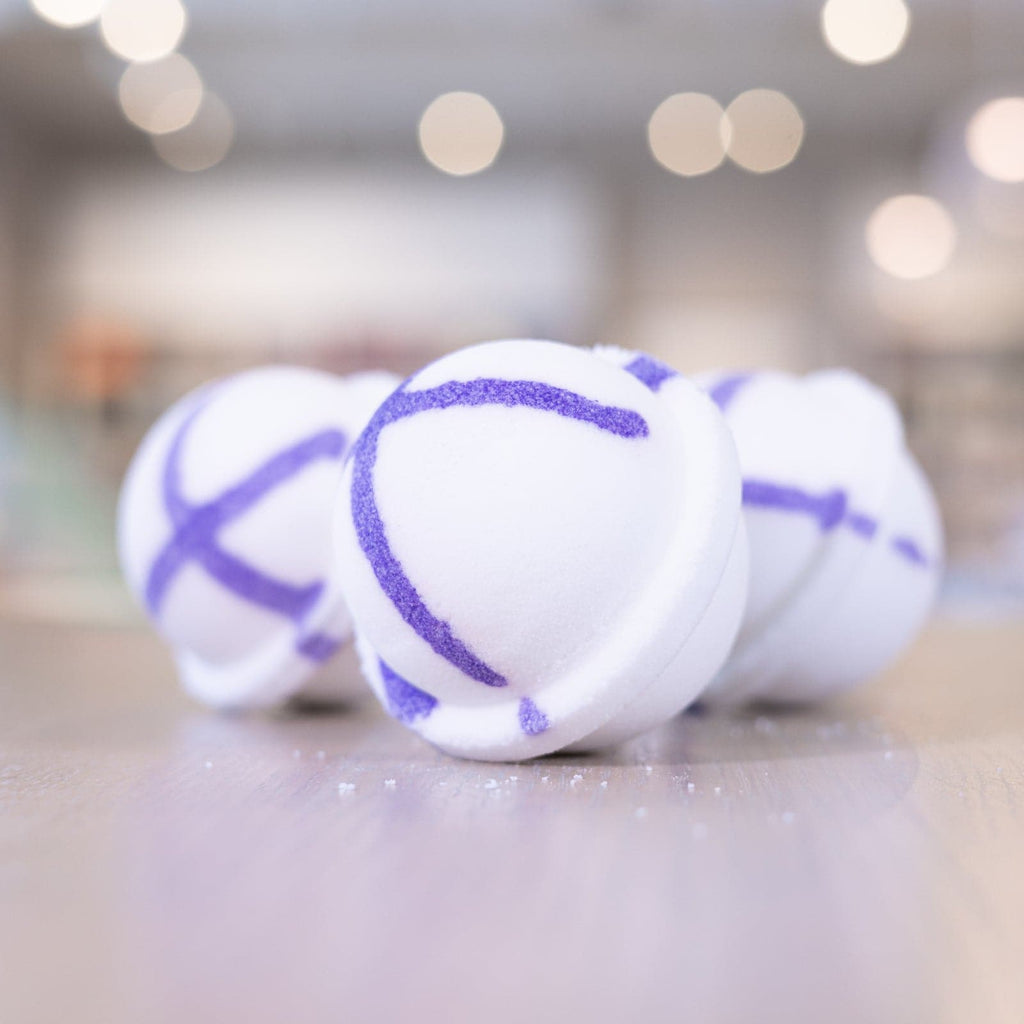 Three Lavender Bath Bombs staggered on counter 