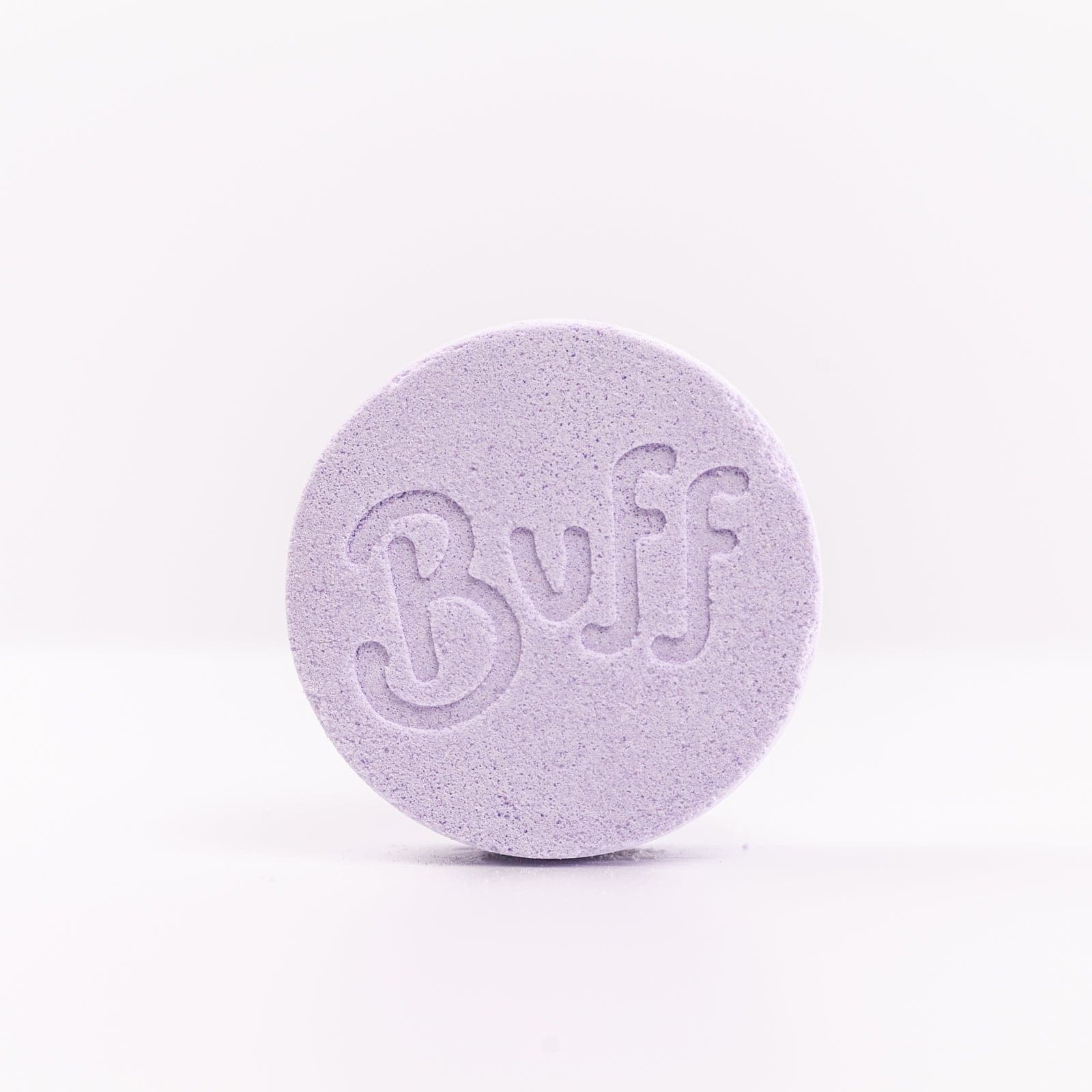 Buff City Soap's lavender colored and scented shower fizzy soap against a white background