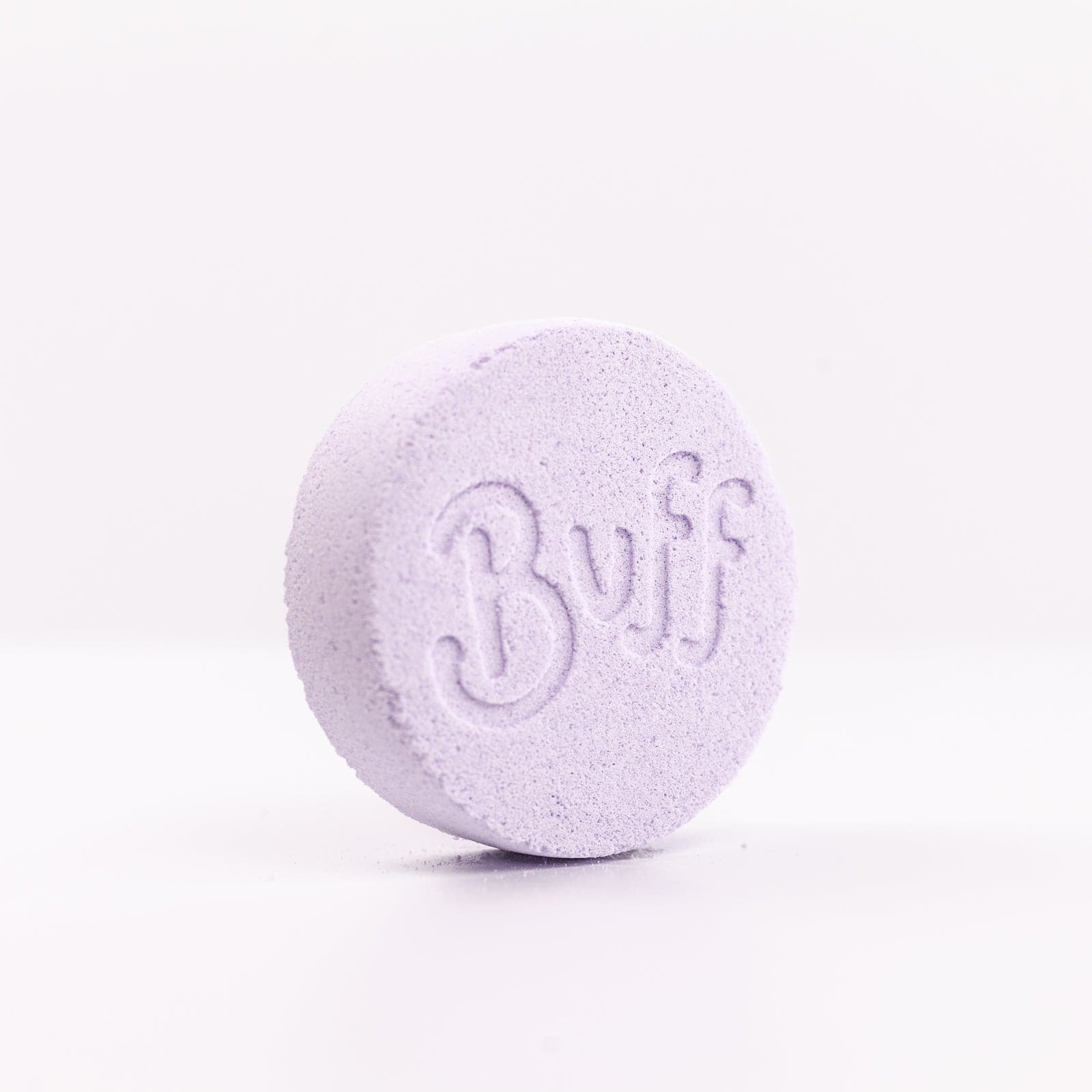 Buff City Soap's lavender colored and scented shower fizzy soap with buff written on its side