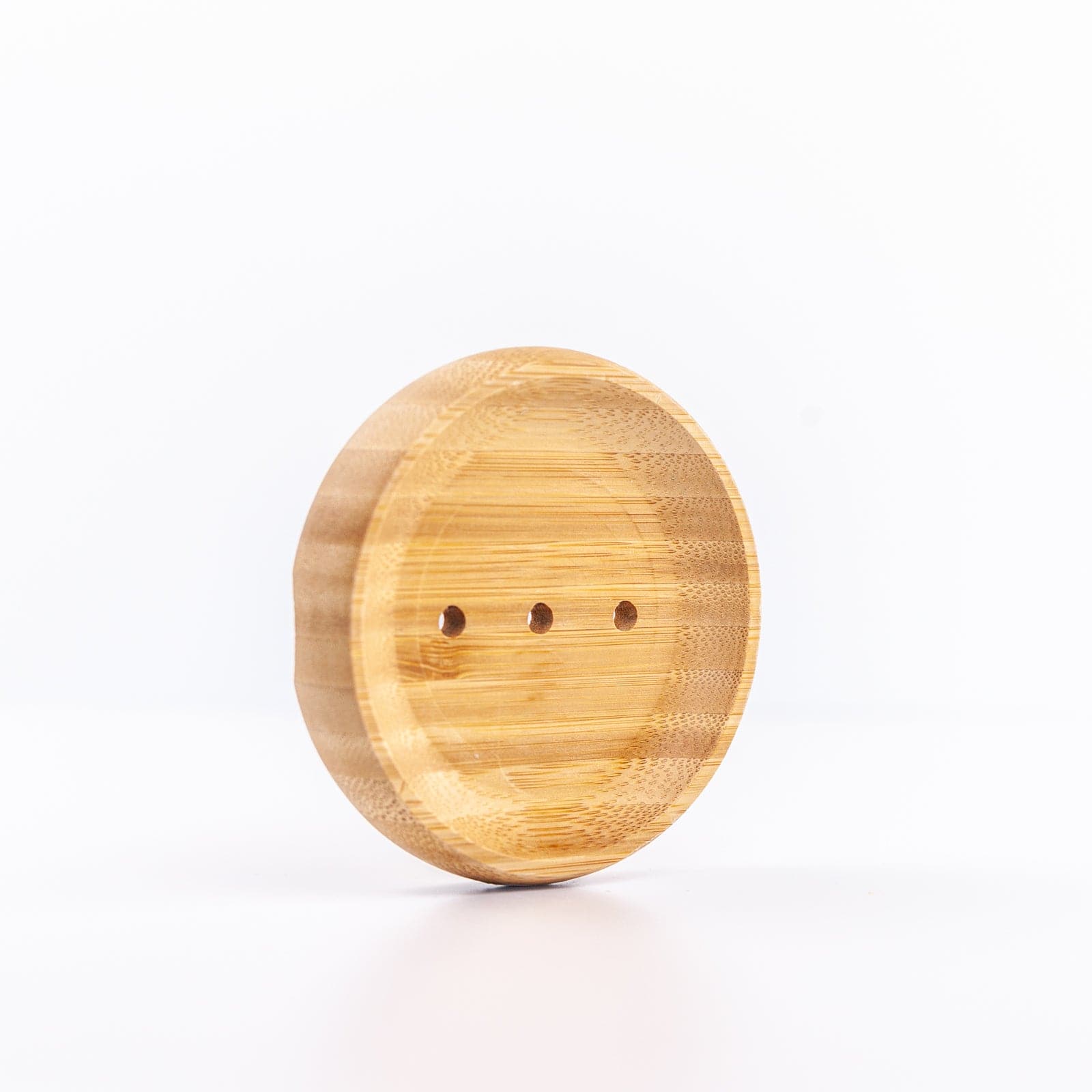 Round wood soap dish against white background 