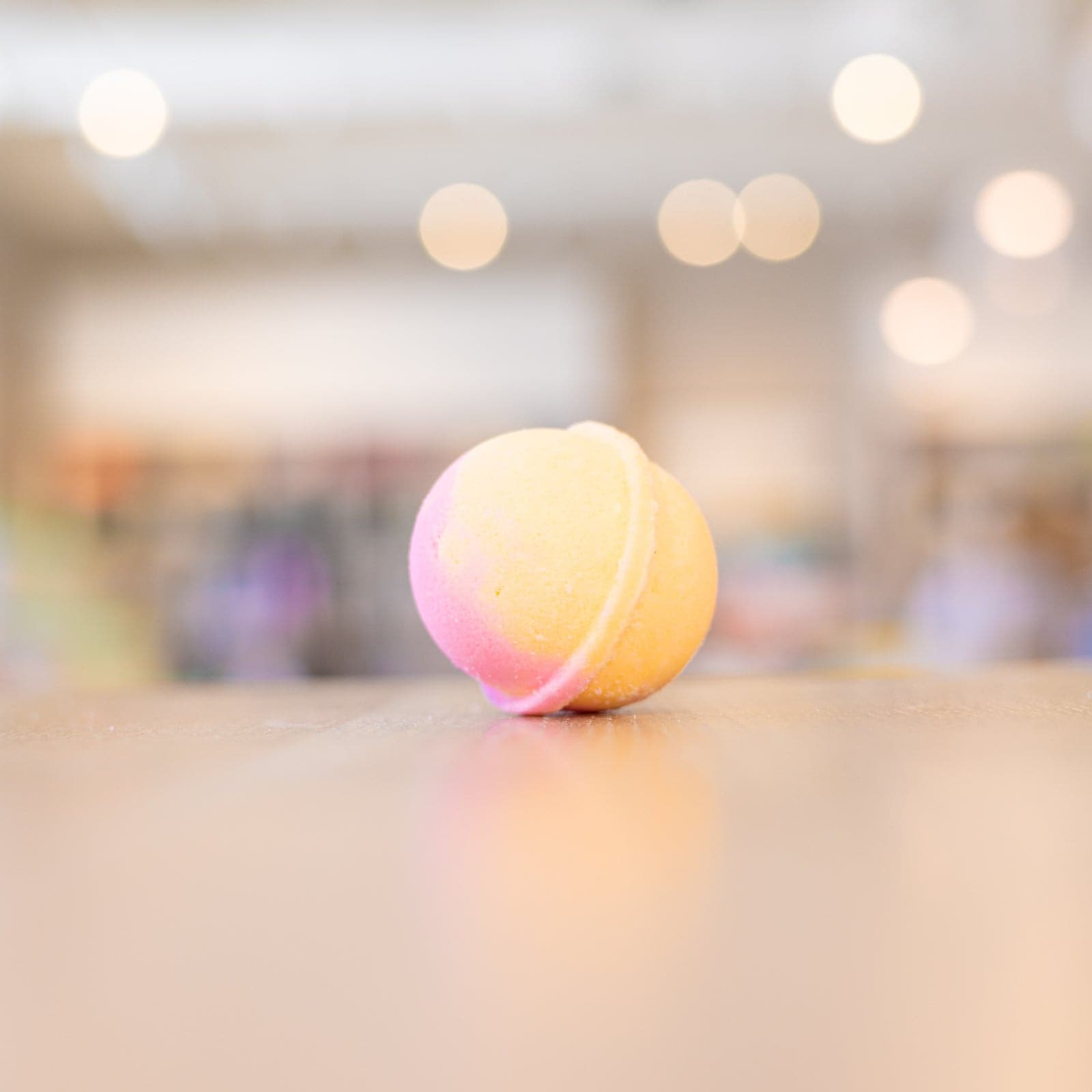 Yellow and pink Sour Candies Mini Bath Bomb on wooden counter