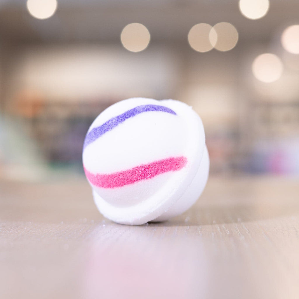 Purple and pink design on white circle bath bomb 